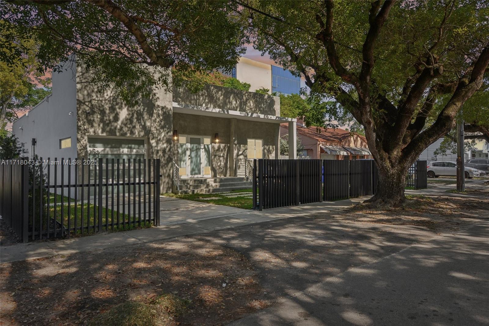 2725 Southwest 19th Street Miami, FL 33145 - Photo 48 of 49 a view of a house with a small yard and a large tree