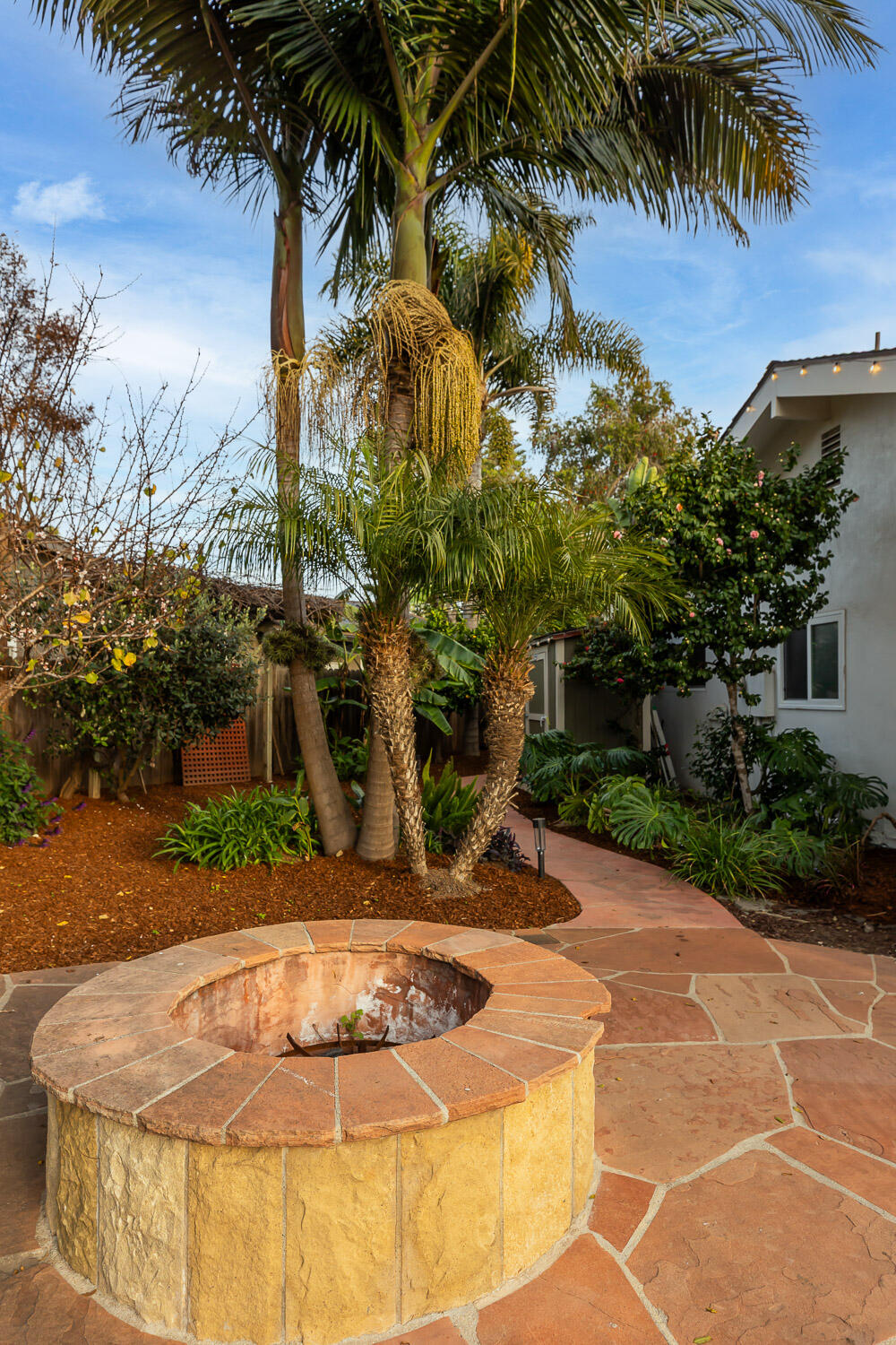 5402 Cameo Road Carpinteria, CA 93013 - Photo 23 of 28 a backyard of a house with table and chairs
