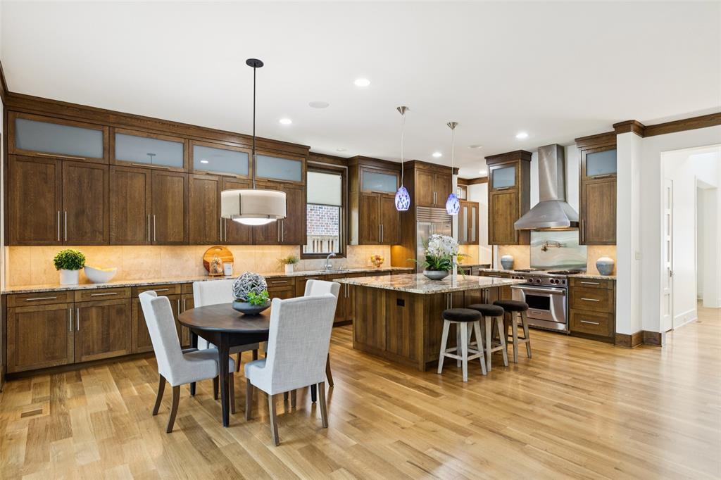 6757 Lakefair Circle Dallas, TX 75214 - Photo 18 of 40 a kitchen with a table and chairs in it