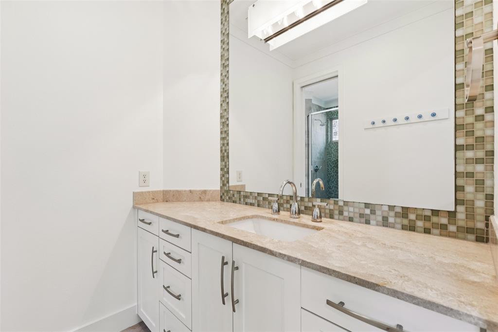 6757 Lakefair Circle Dallas, TX 75214 - Photo 33 of 40 a bathroom with a granite countertop sink and a mirror