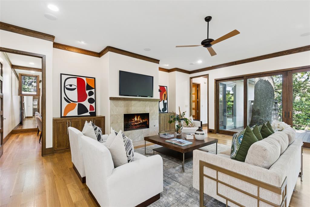 6757 Lakefair Circle Dallas, TX 75214 - Photo 9 of 40 a living room with furniture a fireplace and a flat screen tv