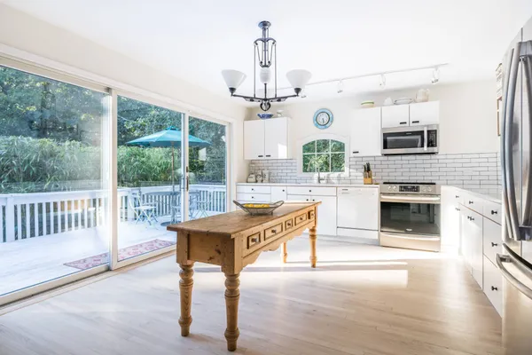 a living room with kitchen island furniture and a fireplace