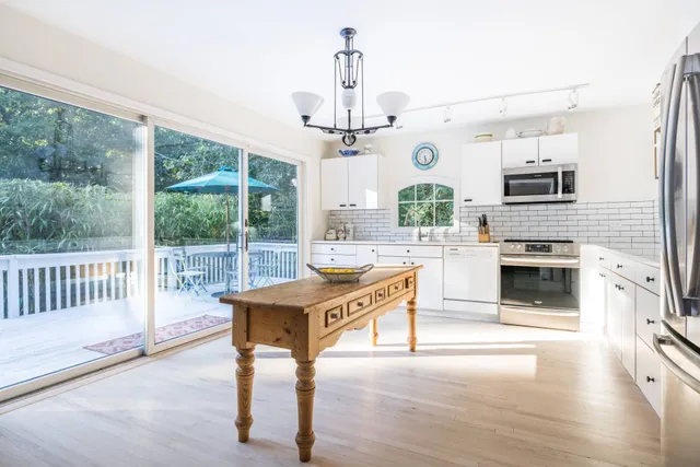 a living room with kitchen island furniture and a fireplace