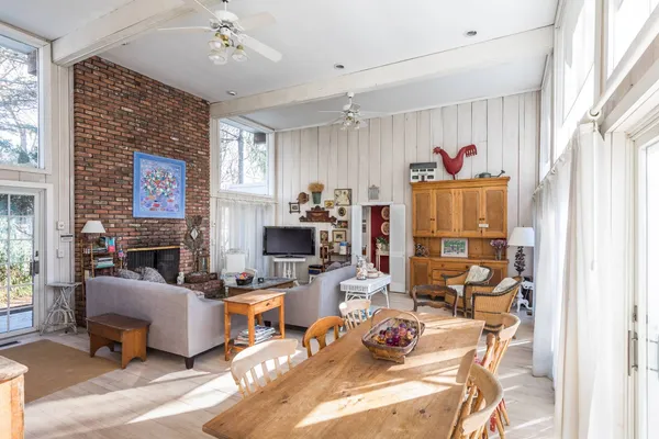 a workspace with furniture a chandelier and a fireplace