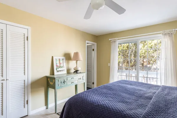 a bedroom with a bed and a large window