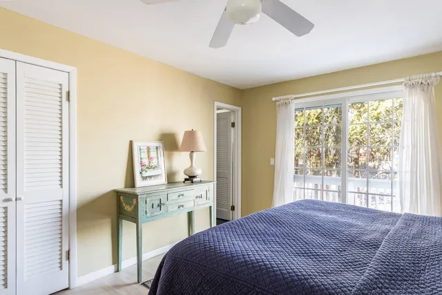 a bedroom with a bed and a large window