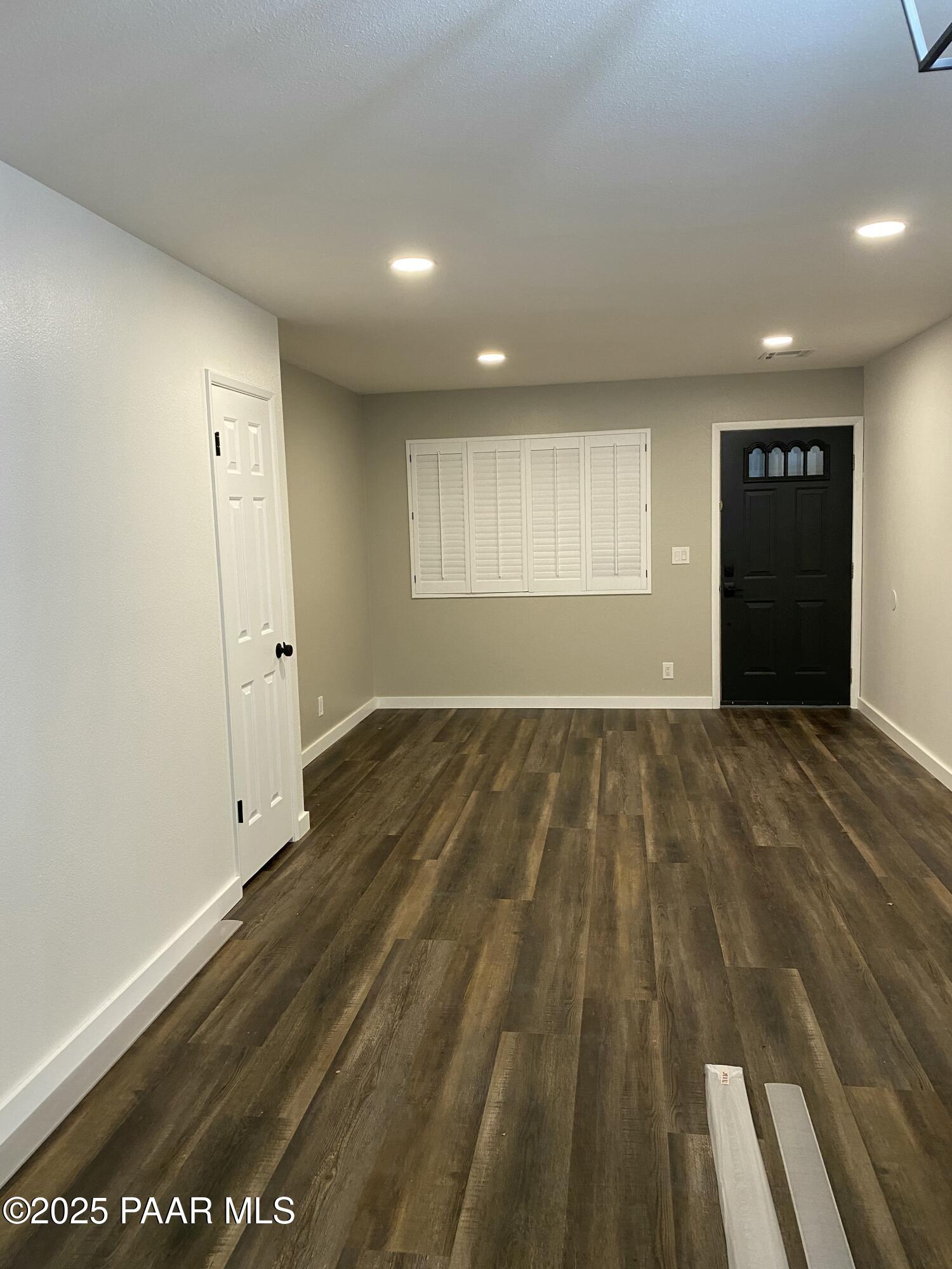 341 Country Club Circle Prescott, AZ 86303 - Photo 5 of 21 an empty room with wooden floor and windows