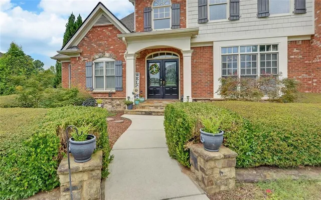 a dining room with furniture potted plants and wooden floor