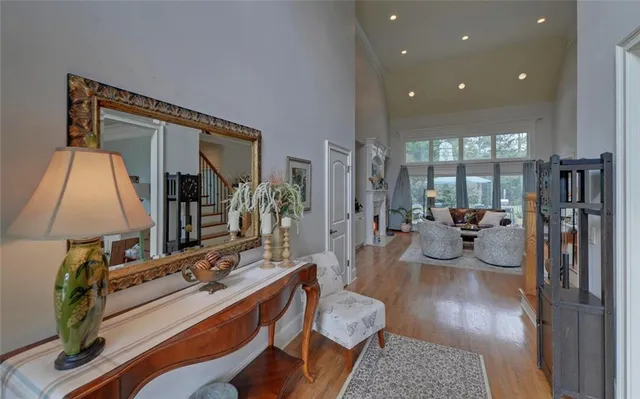 a view of a dining room with furniture a chandelier and wooden floor