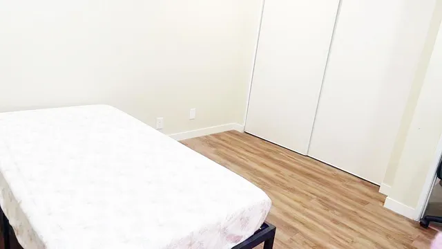 a bed sitting in a bedroom next to a window