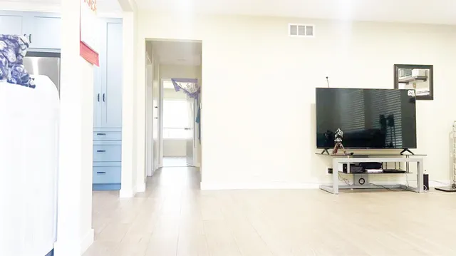 a view of a living room with flat screen tv
