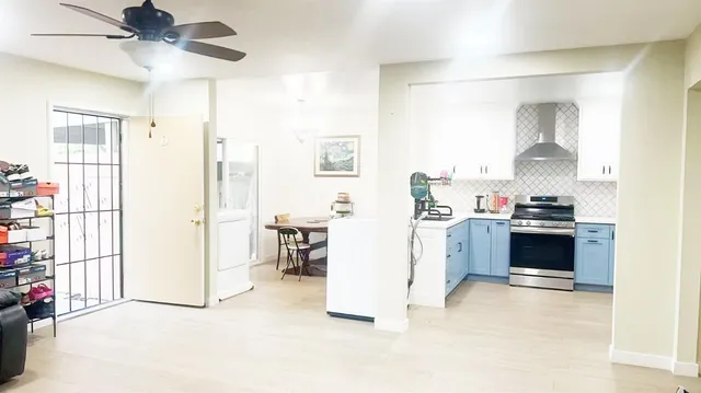 a view of kitchen with furniture and a ceiling fan