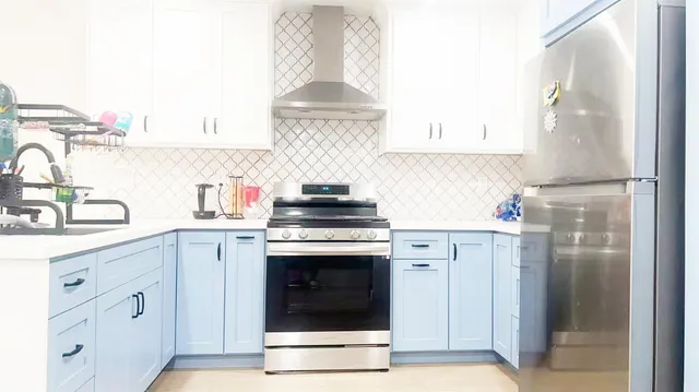 a kitchen with cabinets stainless steel appliances and a counter space