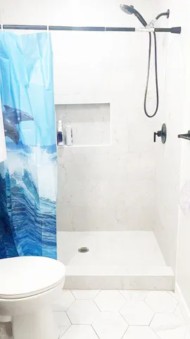 a bathroom with a toilet a sink and a shower