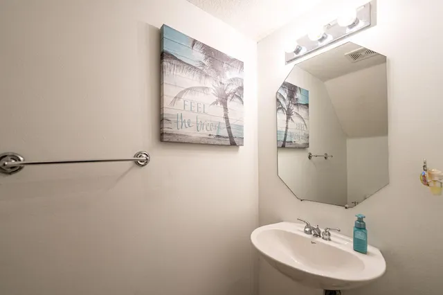 a bathroom with a sink and mirror