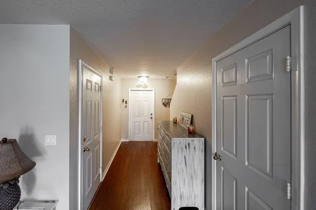 a view of a hallway with a livingroom and a bathroom