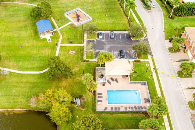 an aerial view of a residential houses with outdoor space and swimming pool