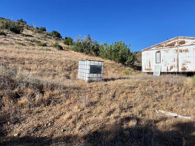 Olympic Way Tehachapi, CA 93561 - Photo 2 of 18 a view of a dry yard with wooden fence