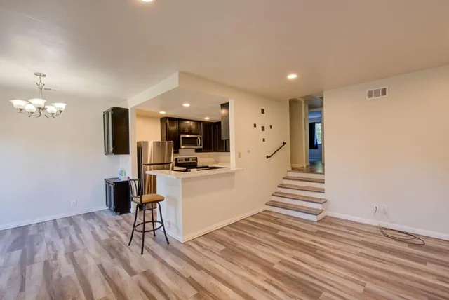 a view of a kitchen with dining room and wooden floor
