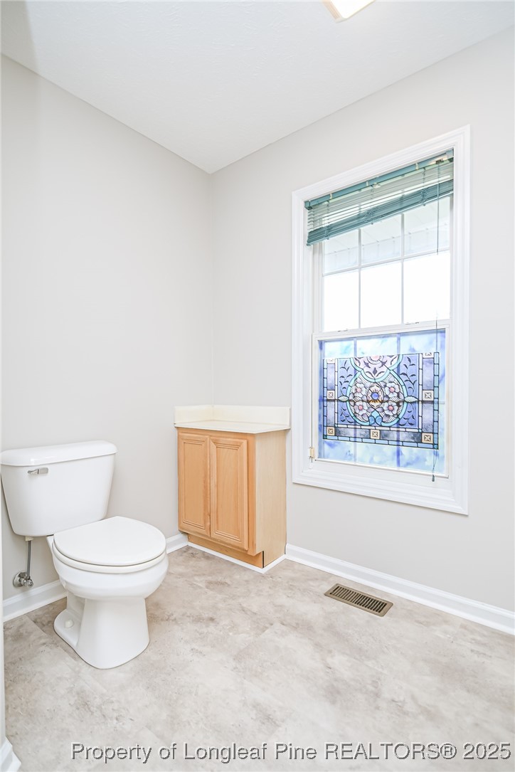4735 Camden Road Fayetteville, NC 28306 - Photo 13 of 34 a bathroom with a toilet and a window