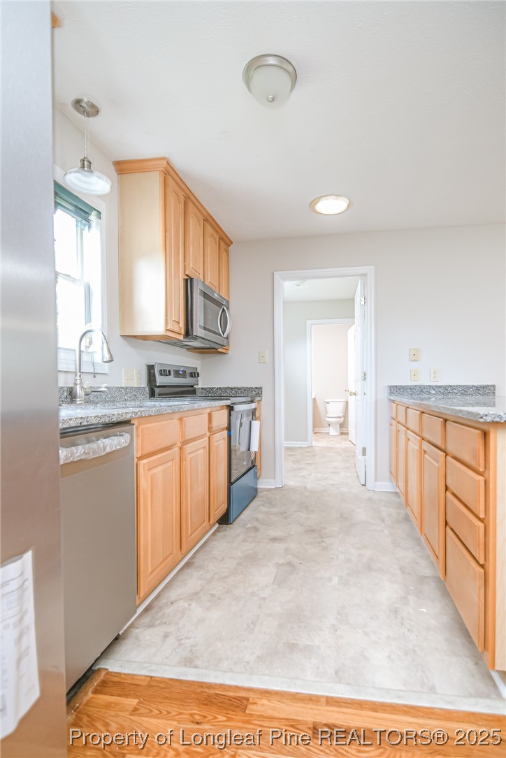 4735 Camden Road Fayetteville, NC 28306 - Photo 20 of 34 a large white kitchen with granite countertop a sink and white cabinets