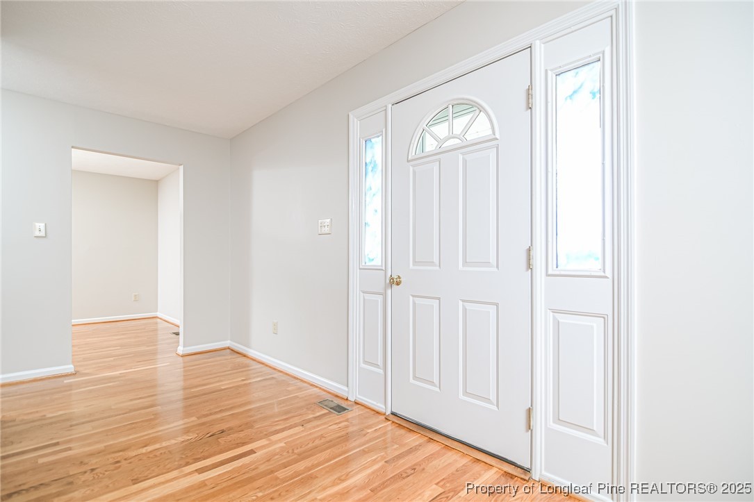 4735 Camden Road Fayetteville, NC 28306 - Photo 2 of 34 a view of a livingroom with wooden floor