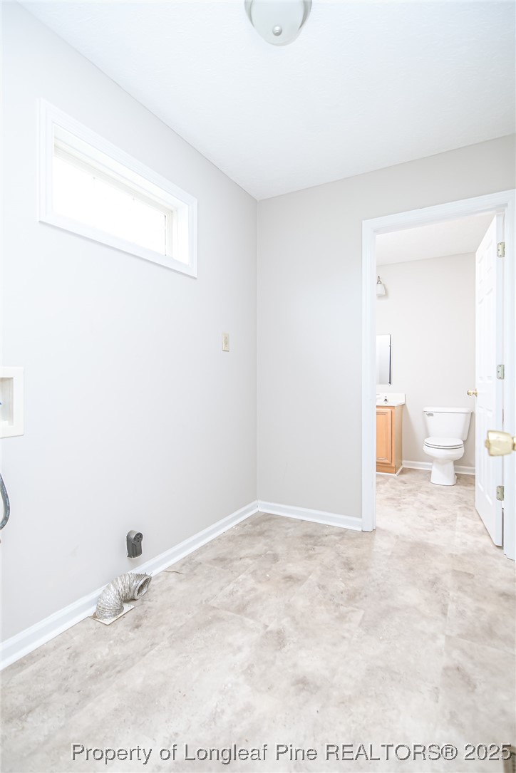 4735 Camden Road Fayetteville, NC 28306 - Photo 21 of 34 a view of a livingroom with wooden floor and bathroom