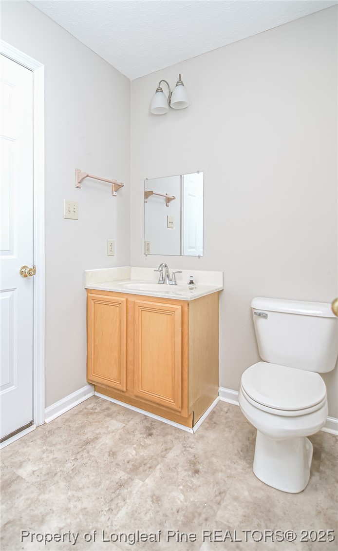 4735 Camden Road Fayetteville, NC 28306 - Photo 22 of 34 a bathroom with a sink a toilet and a mirror