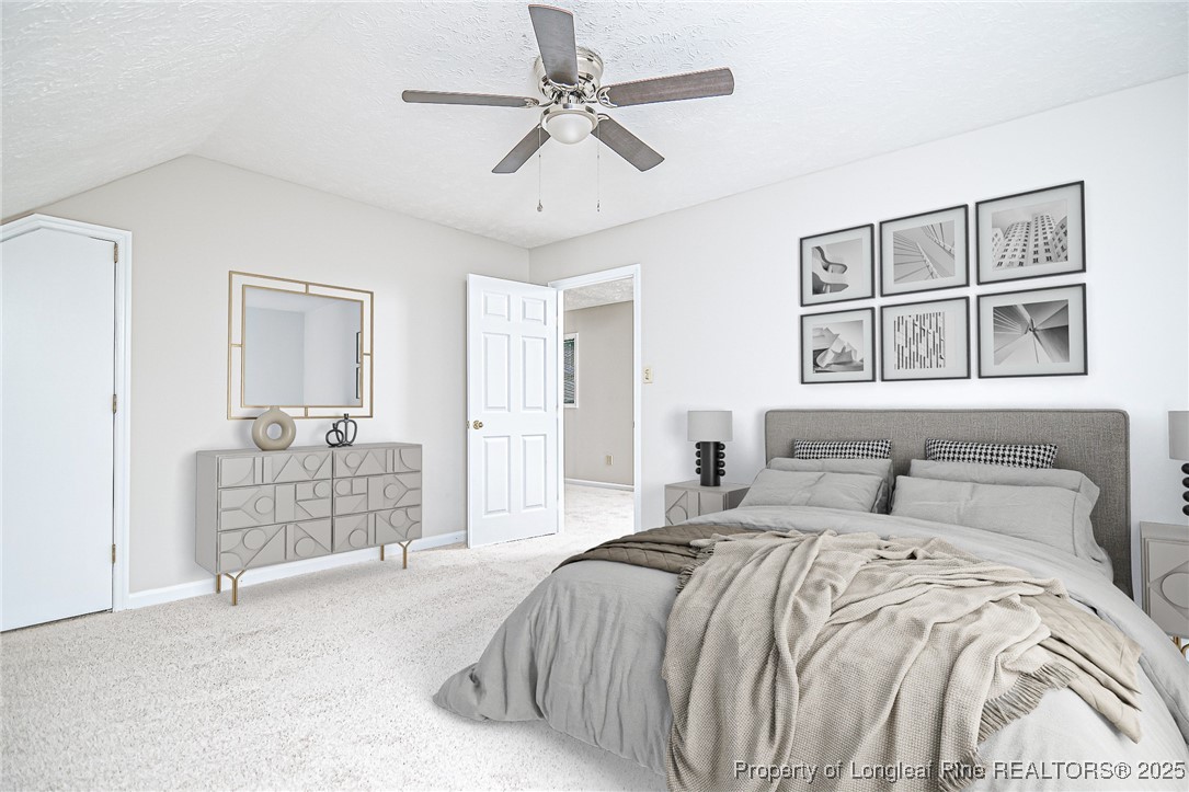 4735 Camden Road Fayetteville, NC 28306 - Photo 28 of 34 a bedroom with a bed and a chandelier
