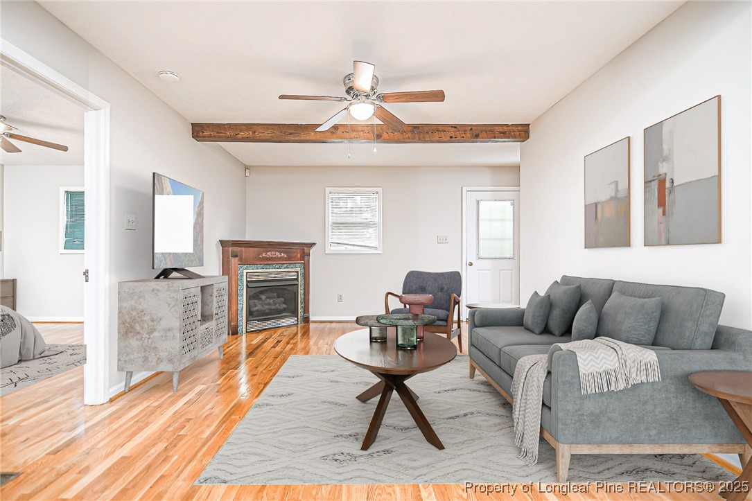 4735 Camden Road Fayetteville, NC 28306 - Photo 4 of 34 a living room with furniture a fireplace and a table