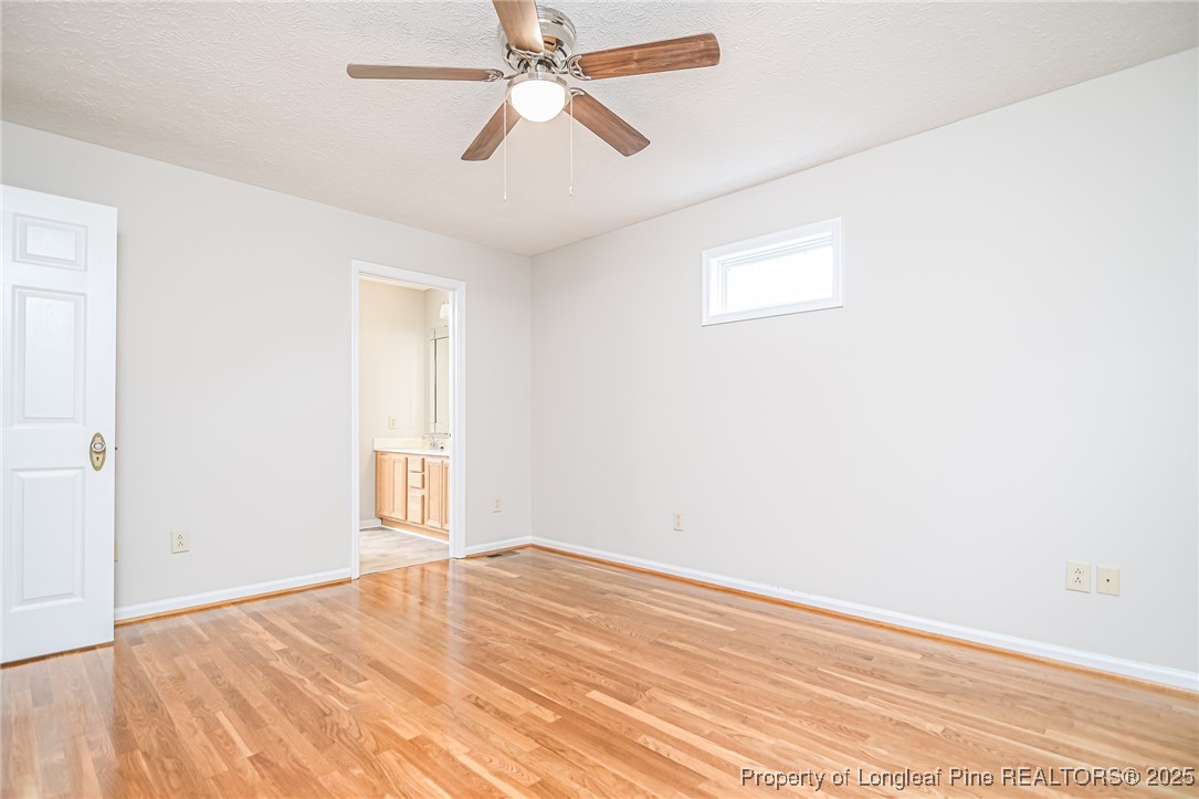 4735 Camden Road Fayetteville, NC 28306 - Photo 10 of 34 an empty room with wooden floor fan and windows