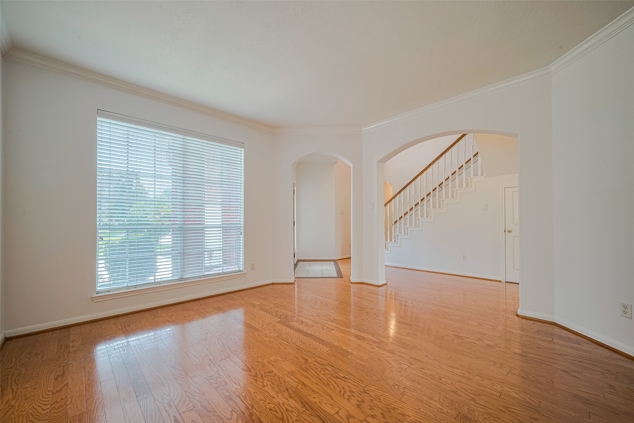 9218 Memorial Pines Way Spring, TX 77379 - Photo 15 of 39 Bright living room located just off the main entrance, featuring elegant engineered wood floors and abundant natural light.