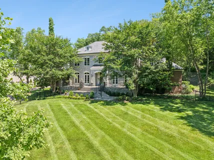 a view of a house with swimming pool and a yard