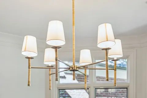 a room with a window and a chandelier