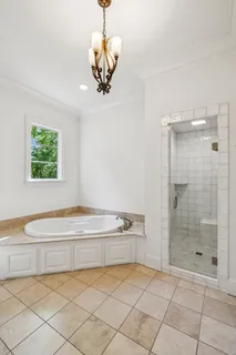 a spacious bathroom with a bathtub and a shower