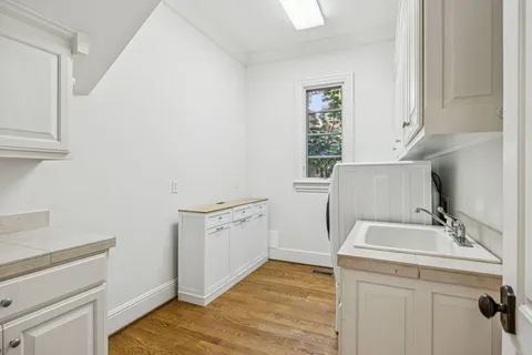 a room with a sink cabinets and appliances