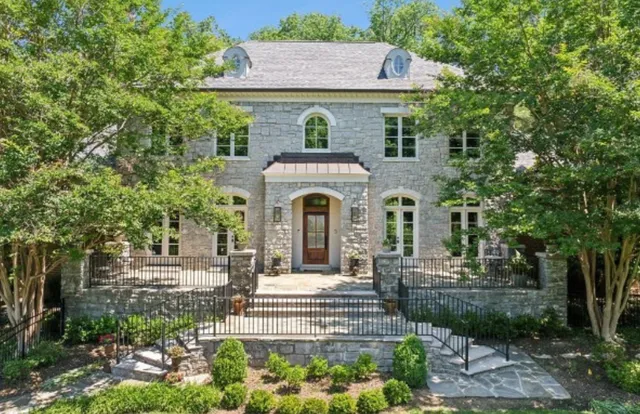 a front view of a house with a garden