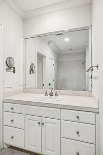 a bathroom with a sink vanity and mirror