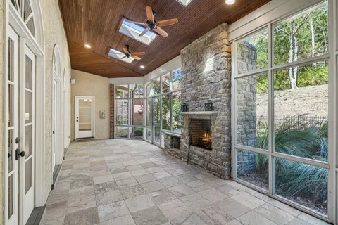 a view of a porch with furniture and a fireplace