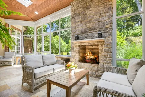 a outdoor living space with patio furniture and a fireplace