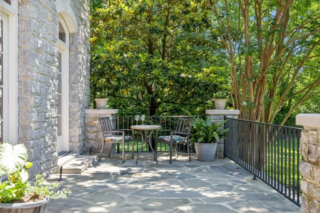 a view of a patio with table and chairs and potted plants
