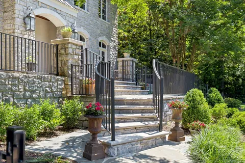 a front view of a house with a garden