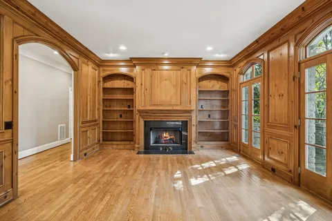 a view of a livingroom with a fireplace cabinet and window