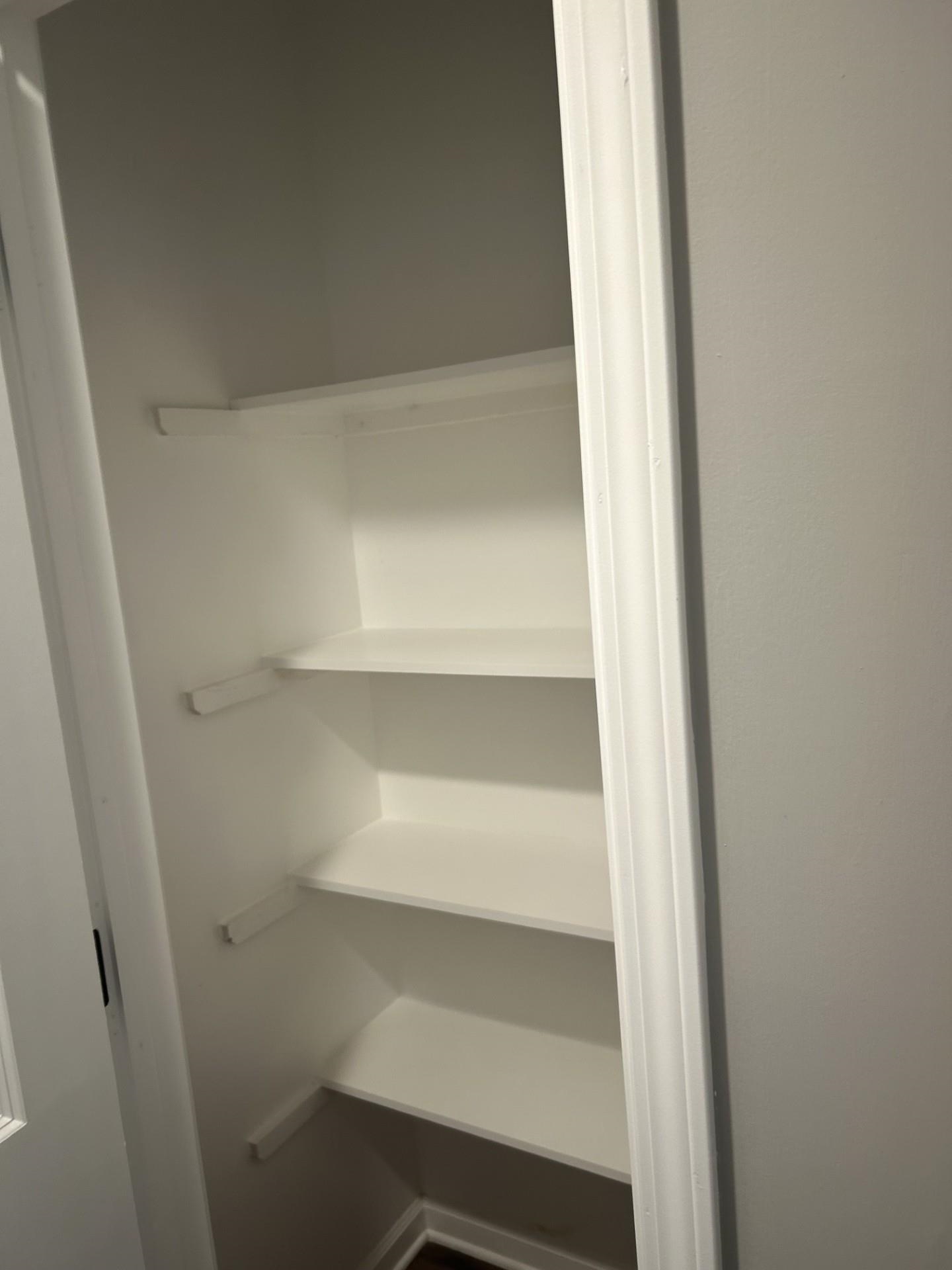 2599 Callie Road Memphis, TN 38127 - Photo 9 of 9 Built-in shelving unit with multiple white shelves, a white door frame, and light gray wall finishes