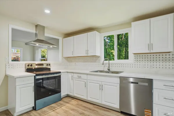 a kitchen with a sink stove and cabinets