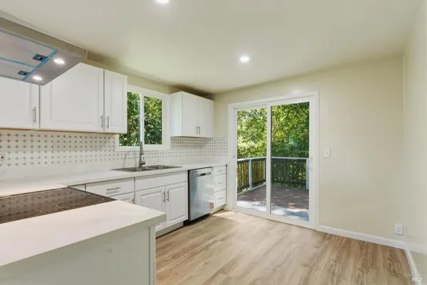 a kitchen with a sink stove and cabinets
