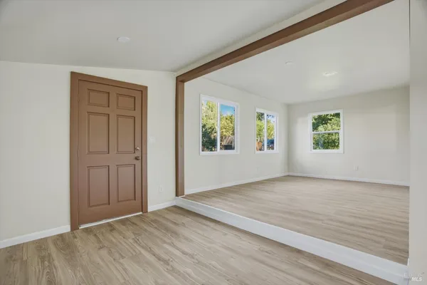 an empty room with windows and closet