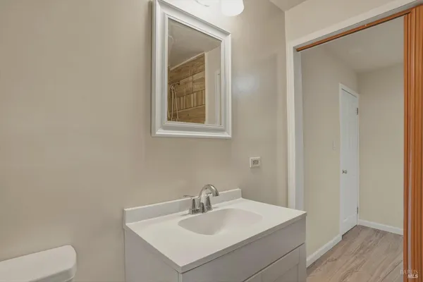 a bathroom with a sink a toilet and a mirror