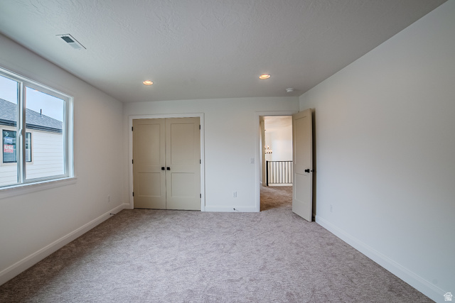 223 South Cottonwood Road, Unit 7501 Vineyard, UT 84059 - Photo 23 of 45 Carpeted room featuring a large window, double closet doors, recessed lighting, and white baseboards