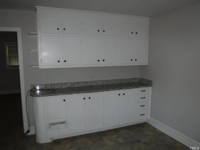 a house that has a tree in front of it